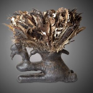 thumbnail of Komo boli made of wood, ulture feathers, bird skull, luminous brown encrustation.