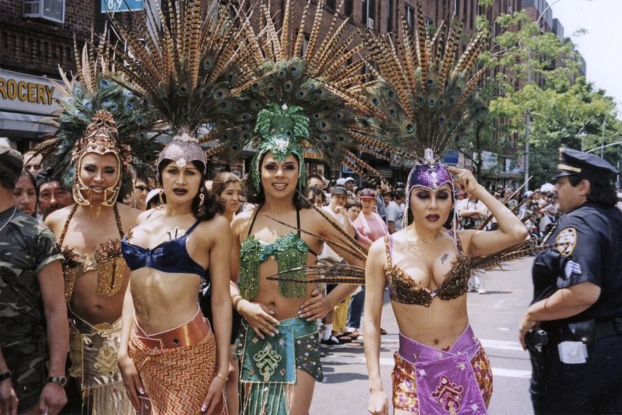 thumbnail of Photo of a group of women with peacock feathers on their heads.