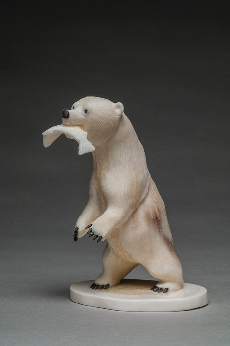 thumbnail of Scultpure of a bear with a fish in its mouth made out of ivory