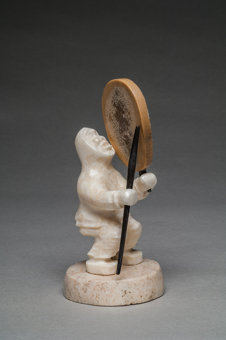thumbnail of Sculpture made out of walrus ivory, bleached seal skin, baleen ink, and old bone base by David Seppilu titled Savoonga, St. Lawrence Island Skin Stretching Scene.