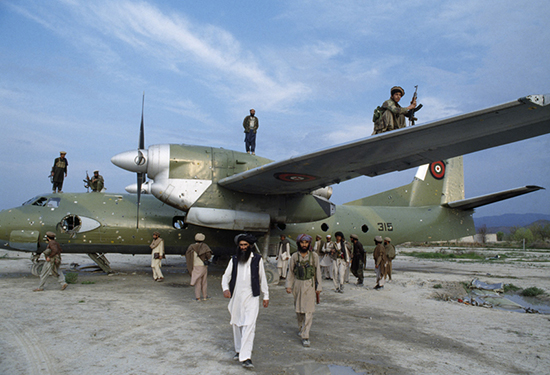 thumbnail of Afghan mujahideen inspect a Kabul government plane after they seized Khost