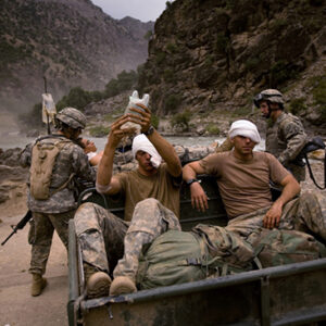 thumbnail of Three wounded US Army soldiers from the 10th Mountain Division are moved for evacuation to a helicopter