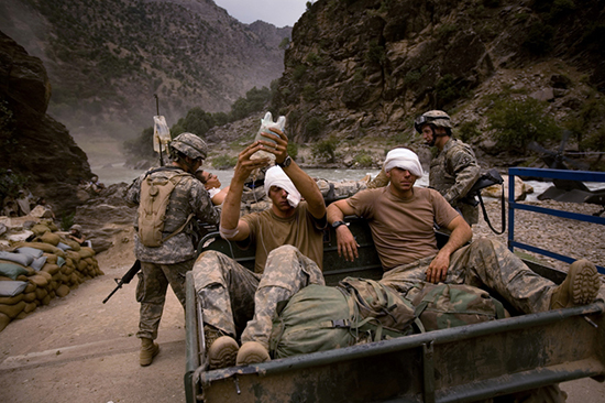 thumbnail of Three wounded US Army soldiers from the 10th Mountain Division are moved for evacuation to a helicopter