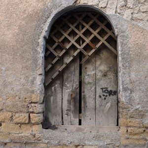 thumbnail of Image of a door with a wooden barrier partially broken over it