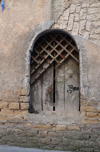 thumbnail of Image of a door with a wooden barrier partially broken over it