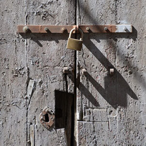 thumbnail of Image of a lock, keeping two gray doors together