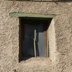 thumbnail of Image of a green door in a rock wall