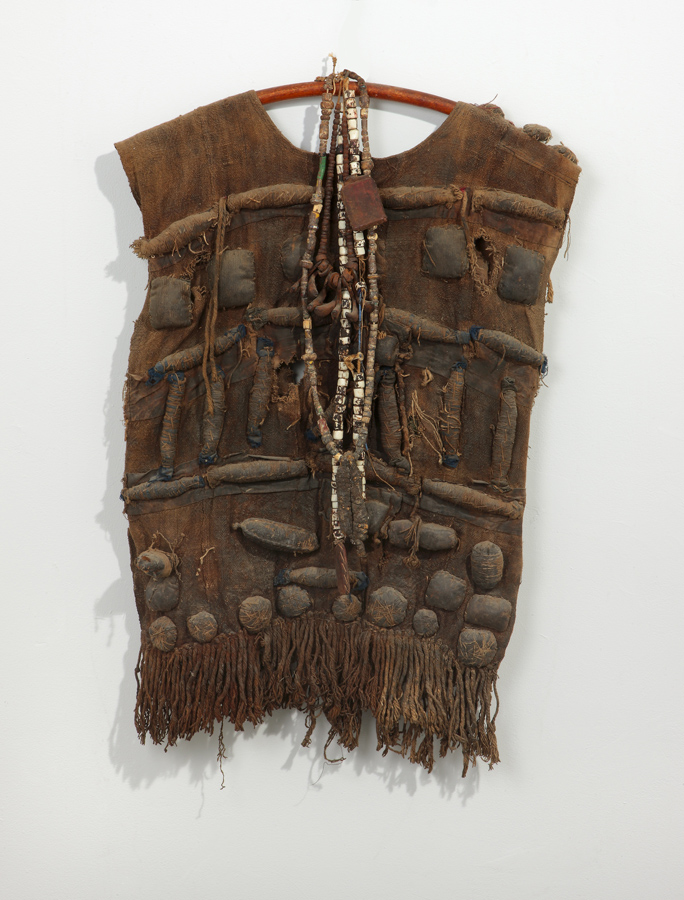 thumbnail of Hunter’s Shirt with Amulets from West Africa. medium: woven raffia, leather, horns. dimensions: height of 27 inches. date: unknown