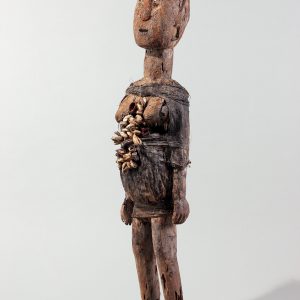 thumbnail of Female Bocio Bound in Blue Cloth from Republic of Benin. medium: Wood, cloth, cowries, brass, white pigment. dimensions: height of 29 inches. date: unknown