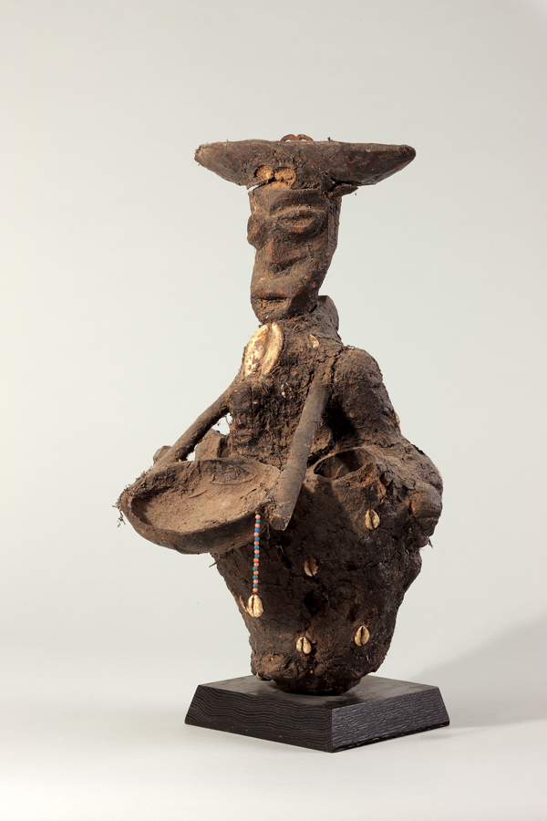 thumbnail of Bocio figure from Republic of Benin. medium: Wood, cloth, cowries, iron, black encrustation. dimensions: height of 19 inches. date: unknown