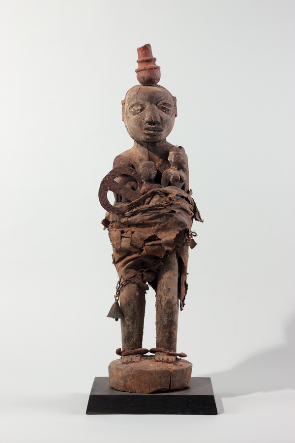 thumbnail of Bocio with pot atop head from Republic of Benin. medium: Wood, iron, cloth, chain, terracotta. dimensions: height of 29 inches. date: unknown