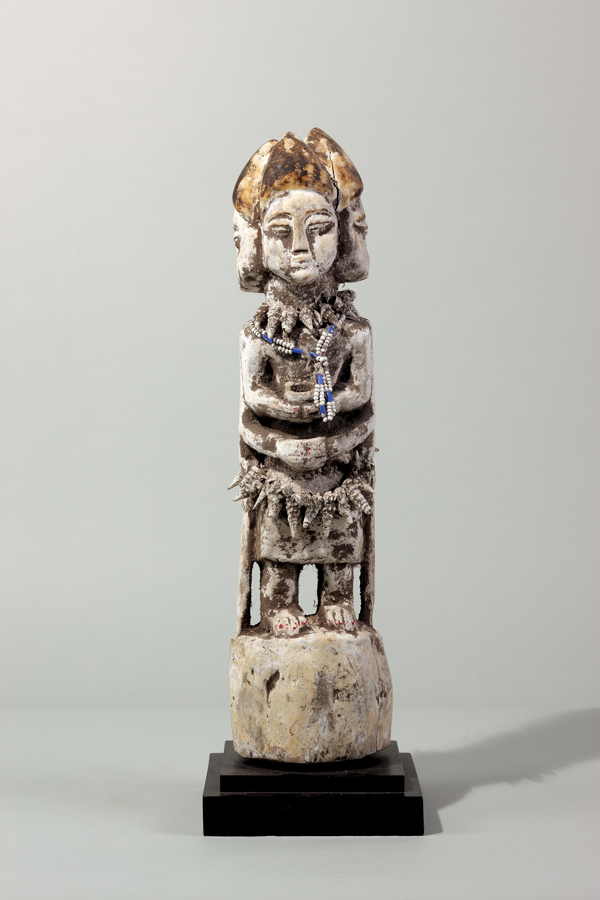 thumbnail of Densu shrine figure from Ewe, Togo. medium: Wood, shells, beads, white pigment. dimensions: height of 20 inches