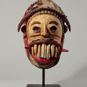 thumbnail of Agaba mask from Igbo, Nigeria. medium: Wood, leather, white, red and black enamel. dimensions: height of 14 inches. date: unknown