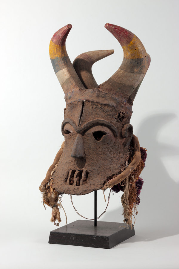 thumbnail of Mgbadike mask from Igbo, Nigeria. medium: Wooden horns, conglomerate face, polychrome. date: unknown