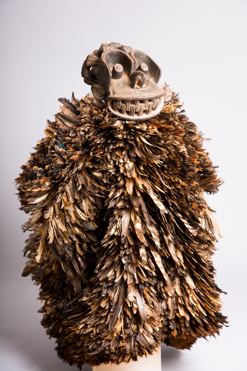 thumbnail of Ceremonial Costume with Mask from Northwestern Grassfields: Kom. medium: Wood, feathers, burlap sack, pigment. date: 19th century