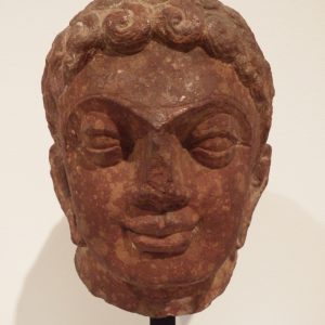 thumbnail of Head of Jain Tirthankara from Mathura region. medium: Red sandstone. date: 2nd century A.D.
