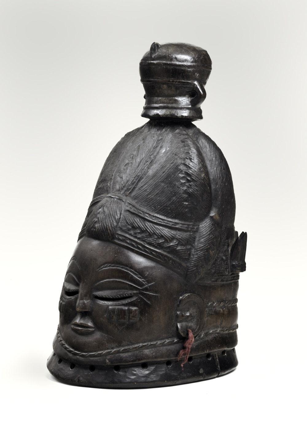 thumbnail of Helmet mask (sowei) from Mende, Sierra Leone. medium: wood, black and brown. dimensions: 15.5 x 9.5 inches