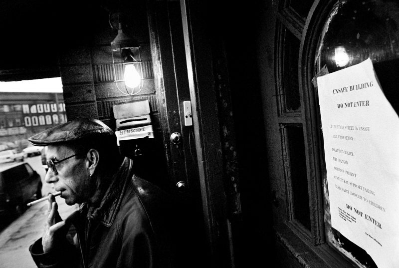 Smoking at Entrance to Apartment Building by Marc Asnin. Medium: Digital print from scanned film. nd.