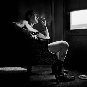 thumbnail of Uncle Charlie contemplating in his living room the reality that his son Joe is dying from HIV, sitting by the window holding his newest and latest handgun in his apartment in Bushwick, Brooklyn in 1996.