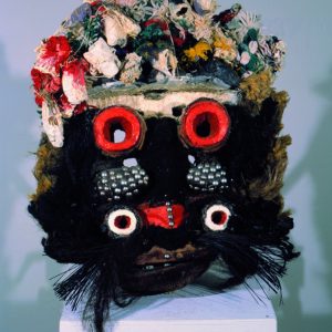 thumbnail of Mask with multiple materials from Liberia/Ivory Coast. medium: fur, raffia, upholstry tacks, etc. date: unknown. height: 18 inches
