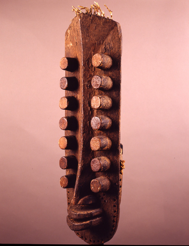 thumbnail of Vertical Mask with 14 'eyes' from Oubi/Grebo complex, Ivory Coast. medium: wood, feather quills. date: unknown. height: 22 inches