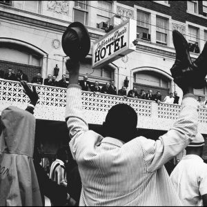 thumbnail of Elated SCLC marchers passing the Jefferson Davis hotel by Dan Budnik. medium: silver gelatin print. date: March, 1965. dimensions: 11 x 16.5 inches