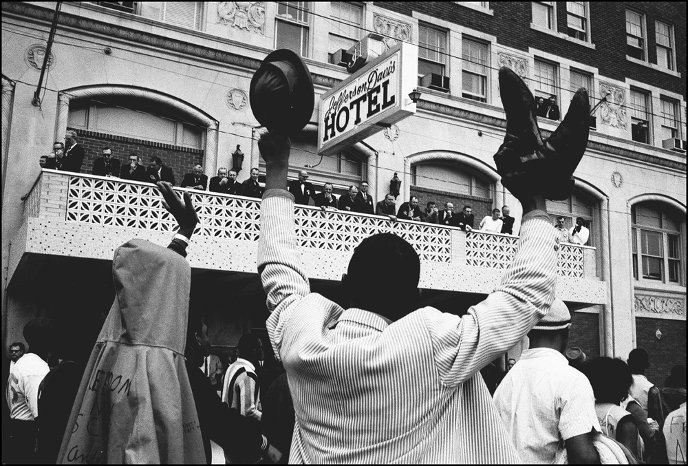 thumbnail of Elated SCLC marchers passing the Jefferson Davis hotel by Dan Budnik. medium: silver gelatin print. date: March, 1965. dimensions: 11 x 16.5 inches