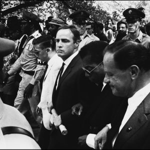 thumbnail of March on Washington Marlon Brando, James Baldwin, Joseph Mankiewicz marching to the Lincoln Memorial by Dan Budnik. medium: silver gelatin print. date: August, 1965. dimensions: 11 x 16.5 inches