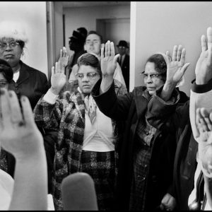 thumbnail of Newly registered citizens taking the oath to become voters, Montgomery County courthouse by Dan Budnik. medium: silver gelatin print. date: 1965. dimensions: 8.25 x 12 inches