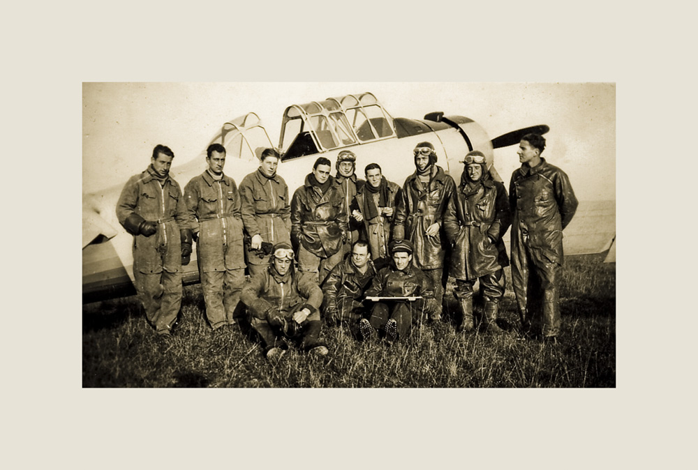thumbnail of The Deblencourt Team Comrades in Front of their Plane by artist Patricia Dreyfus. medium: c-print. date: 1942. dimensions: 12.96 x 18.84 inches