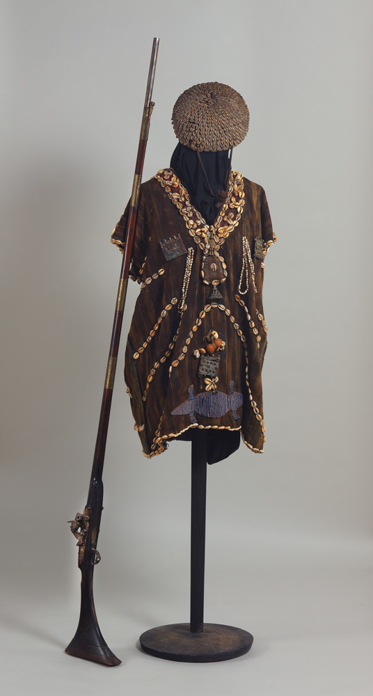 thumbnail of Royal Hunter's Ensemble, Cowrie Hat, and Gun from Yoruba, Nigeria. medium: Fabric, beads, cowries, amulets, brass bells, leather, long rifle. date: unknown. dimensions: unknown.