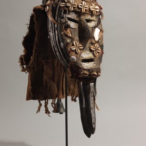 thumbnail of Poro Society Mask from Loma/Toma, Liberia/Guinea. medium: Wood, brown and red cloth, white metal, mirrors, horns, cowries, bell. date: unknown. dimensions: unknown