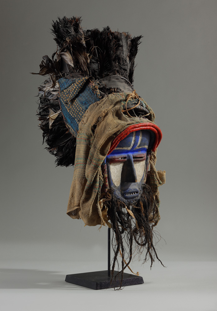 thumbnail of Mask from Grebo or Wè (Ngere), Ivory Coast/Liberia. medium: Wood, pigments, fabric, metal, raffia, red plastic beads. date: unknown. dimensions: unknown.