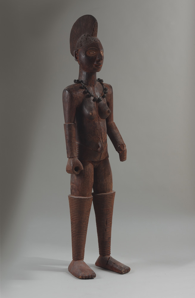 thumbnail of Display Figure from Igbo, Nigeria. medium: wood, brass bells, kaolin. dimensions: unknown. date: unknown.