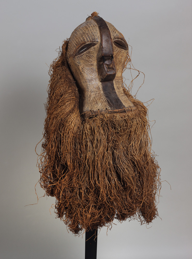 thumbnail of Kifwebe Mask from Songye, Democratic Republic of Congo. medium: wood, raffia, kaolin pigment. dimensions: unknown. date: unknown