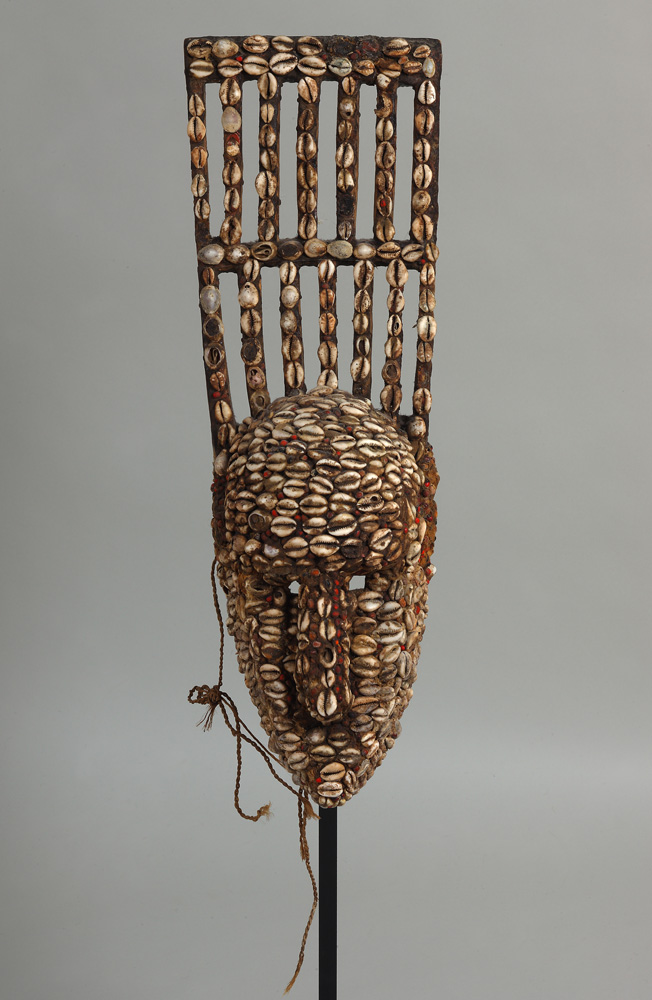 thumbnail of N'Tomo Mask from Bamana, Mali. medium: wood, cowrie shells, abrus precatorius seeds, wax or resin. date: unknown. dimension: unknown.